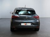 the rear end of a grey car in a white room