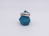 a close up of a ring with a diamond on top of it