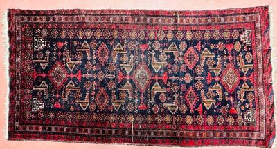 a close up of a blue and red rug on a pink background