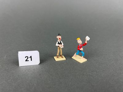 deux figurines d'un homme et d'une femme debout l'un à côté de l'autre