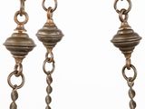 three antique brass chains hanging from the ceiling of a room
