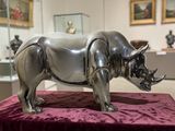 a rhino statue sitting on a table in a museum
