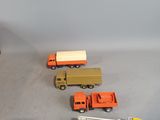 several toy trucks are lined up on a table next to each other