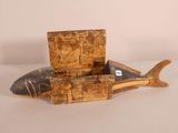 an old wooden box with a fish inside of it sitting on a table