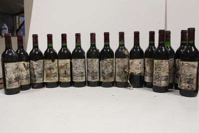 several bottles of wine are lined up in a row on a table