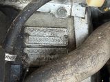 a close up of a car engine with a hose attached