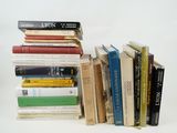 many books stacked on top of each other on a table