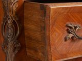 a wooden chest of drawers with a marble top