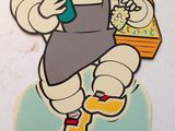 un autocollant représentant un personnage de dessin animé tenant une bouteille et un panier