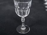 several empty wine glasses sitting on a table with a black background