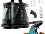 un aspirateur posé par terre, muni d'une brosse