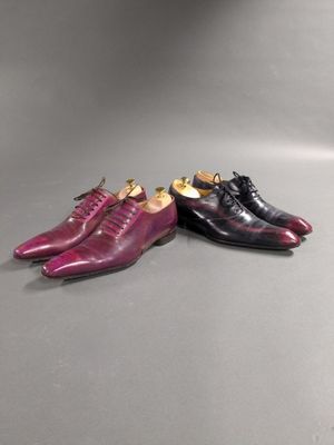 a pair of purple and black shoes sitting next to each other