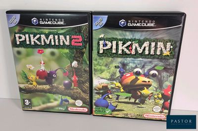 two video game cases of pikmin and pikmin on a table