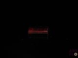 a red light in the middle of a dark room