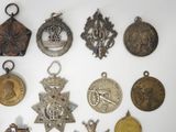 a lot of medals on display on a white surface