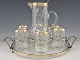an image of a glass and brass tea set on a tray
