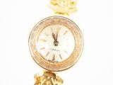 an image of a close up of a wrist watch with a pineapple on it