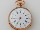 a gold pocket watch with roman numerals on the face