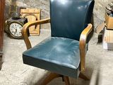 a chair that is sitting in a room with a clock