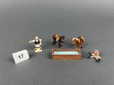 a small figurine of a man riding a horse and a man on a motorcycle