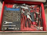 many tools in a tool box on the floor