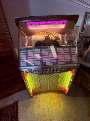 a juke box sitting on the floor in a living room