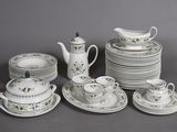 many plates, cups, and saucers that are sitting on a table
