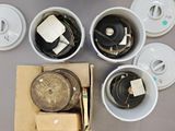 four cups of water and a box of lids on a table