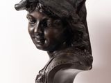 a statue of a boy with a hat on his head