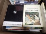 many books that are sitting in a box on the table