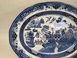 a blue and white plate with a picture on it