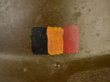 an image of a close up of a metal object with a red, yellow, and black stripe