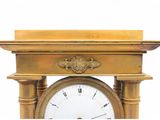 a gold clock with a white face on a white background