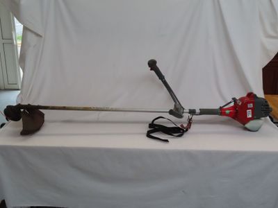 a picture of a red and black pole saw on a white table