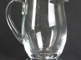 a glass pitcher that is sitting on a table