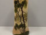 a vase with a painting on it sitting on a table