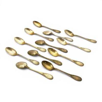 several spoons and spoon spoons are lined up on a white surface