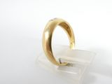 a close up of a gold ring with diamonds on a clear surface