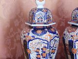 two blue and white vases sitting on a table