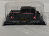 a close up of a black toy car in a clear box