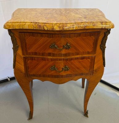 an antique wooden chest of drawers with a marble top