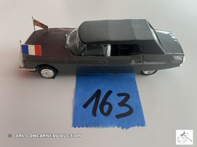 une petite voiture avec un drapeau à l'arrière