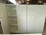 a large white cabinet in the middle of a room