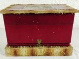 a small red box with a picture on top of it