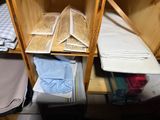 a shelf that has a lot of folded clothes on it