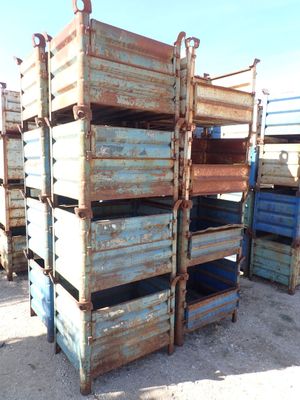 many crates stacked on top of each other in the dirt