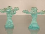 two glass candlesticks that are sitting on a table