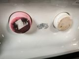 a white sink with two bowls of food on it