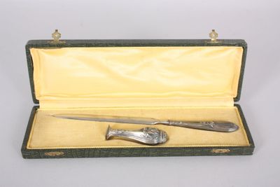 a silverware set in a green case on a white surface