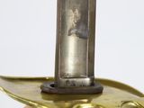 a gold colored candle holder with a candle on it
